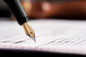 pen-writing-on-legal-document